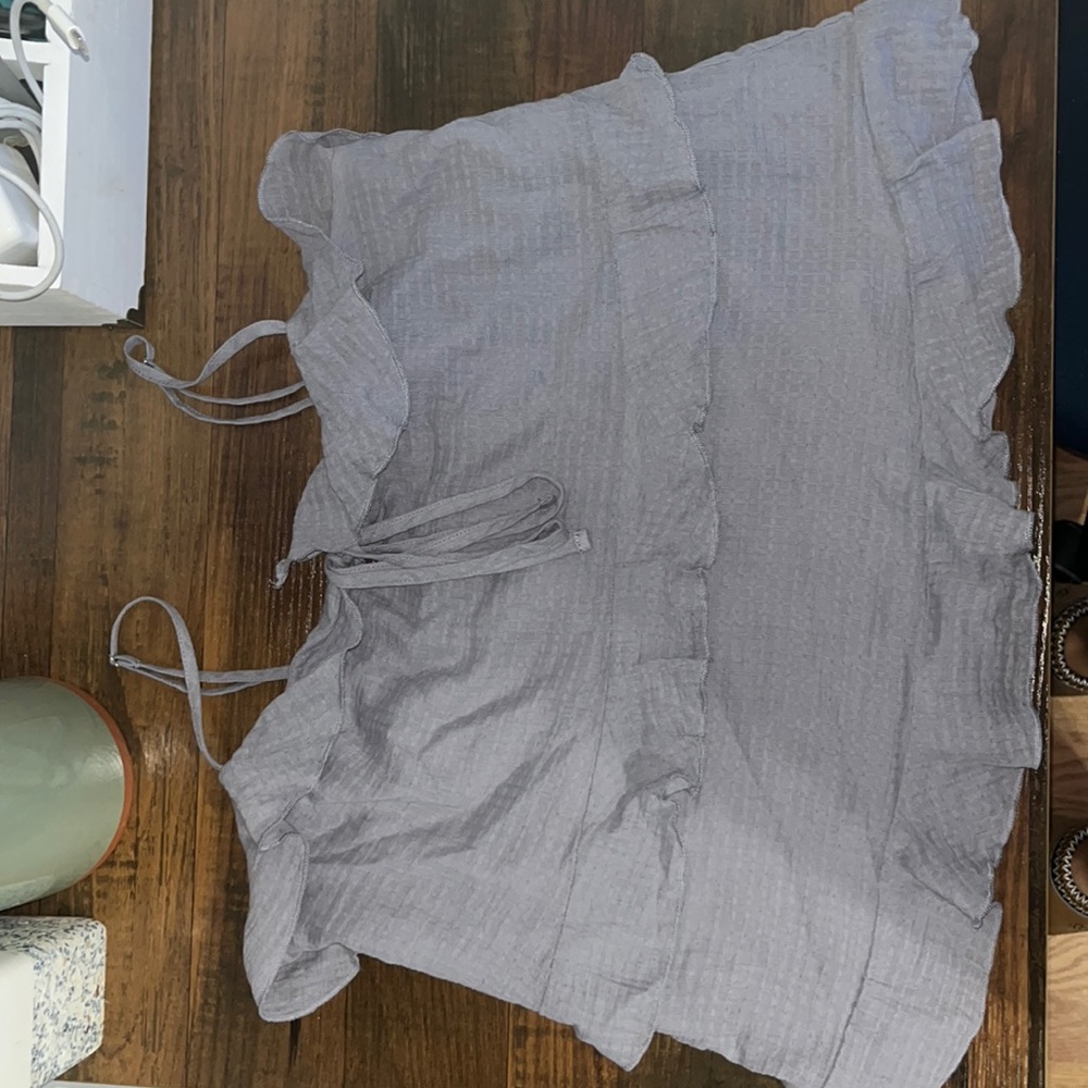 A purple tank top with ruffles